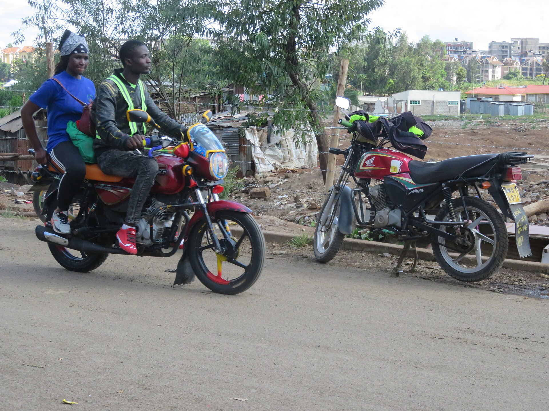 Two motorcycle taxis, known as boda bodas, on a road in Nairobi
