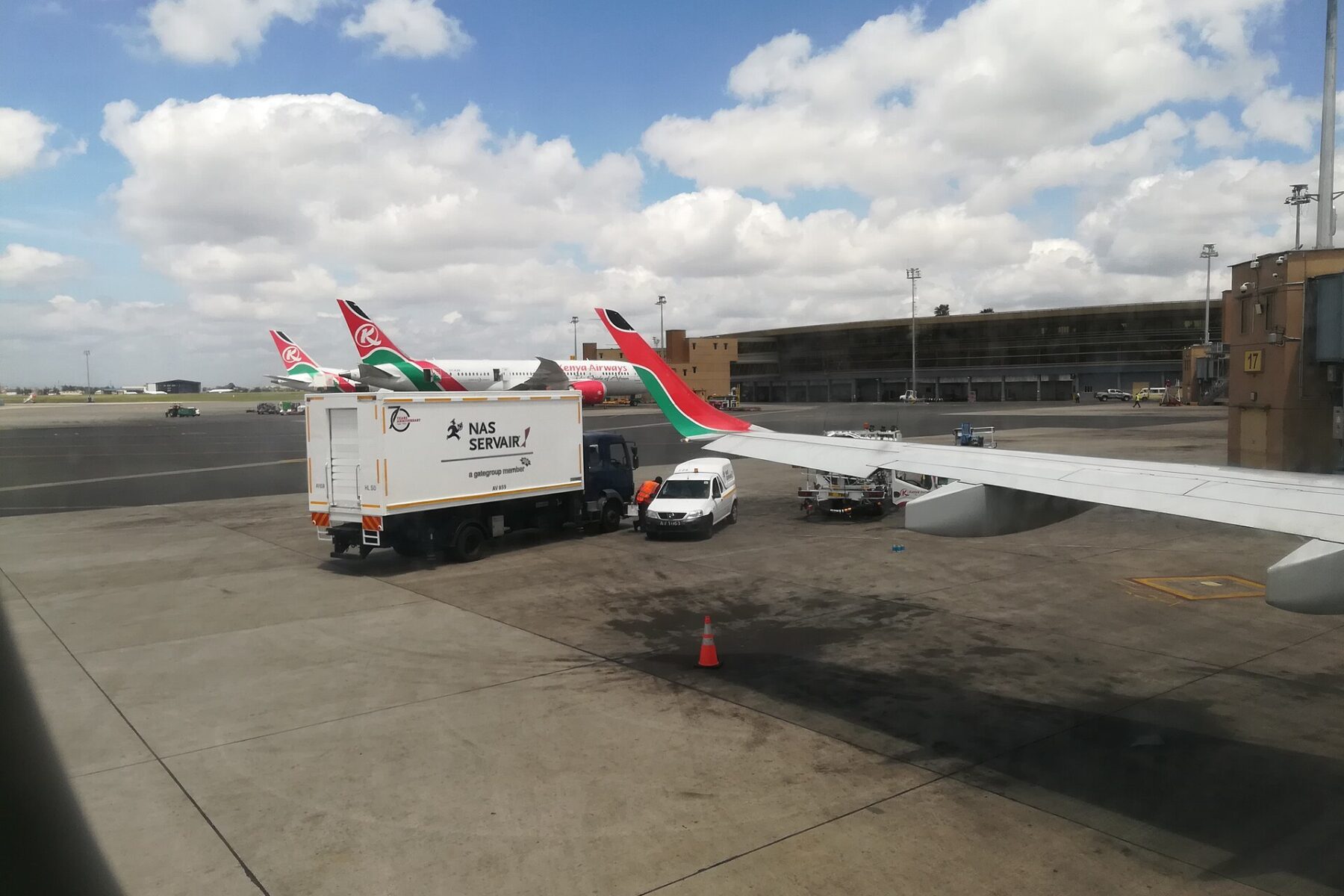 Kenya Airways aircraft and ground service vehicles on the apron at Jomo Kenyatta International Airport in Nairobi