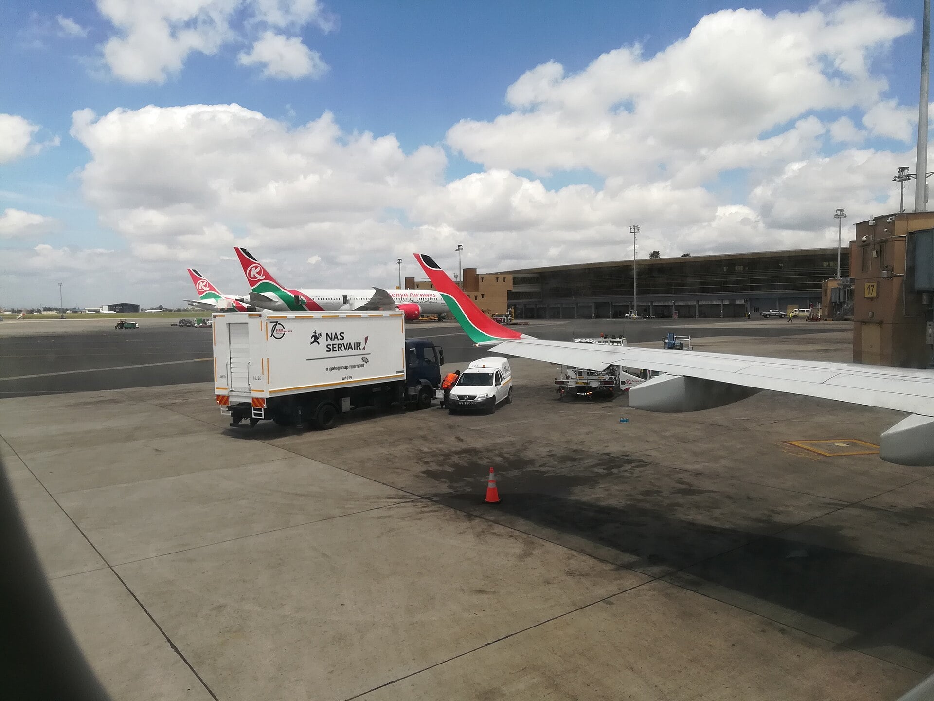 Kenya Airways aircraft and ground service vehicles on the apron at Jomo Kenyatta International Airport in Nairobi