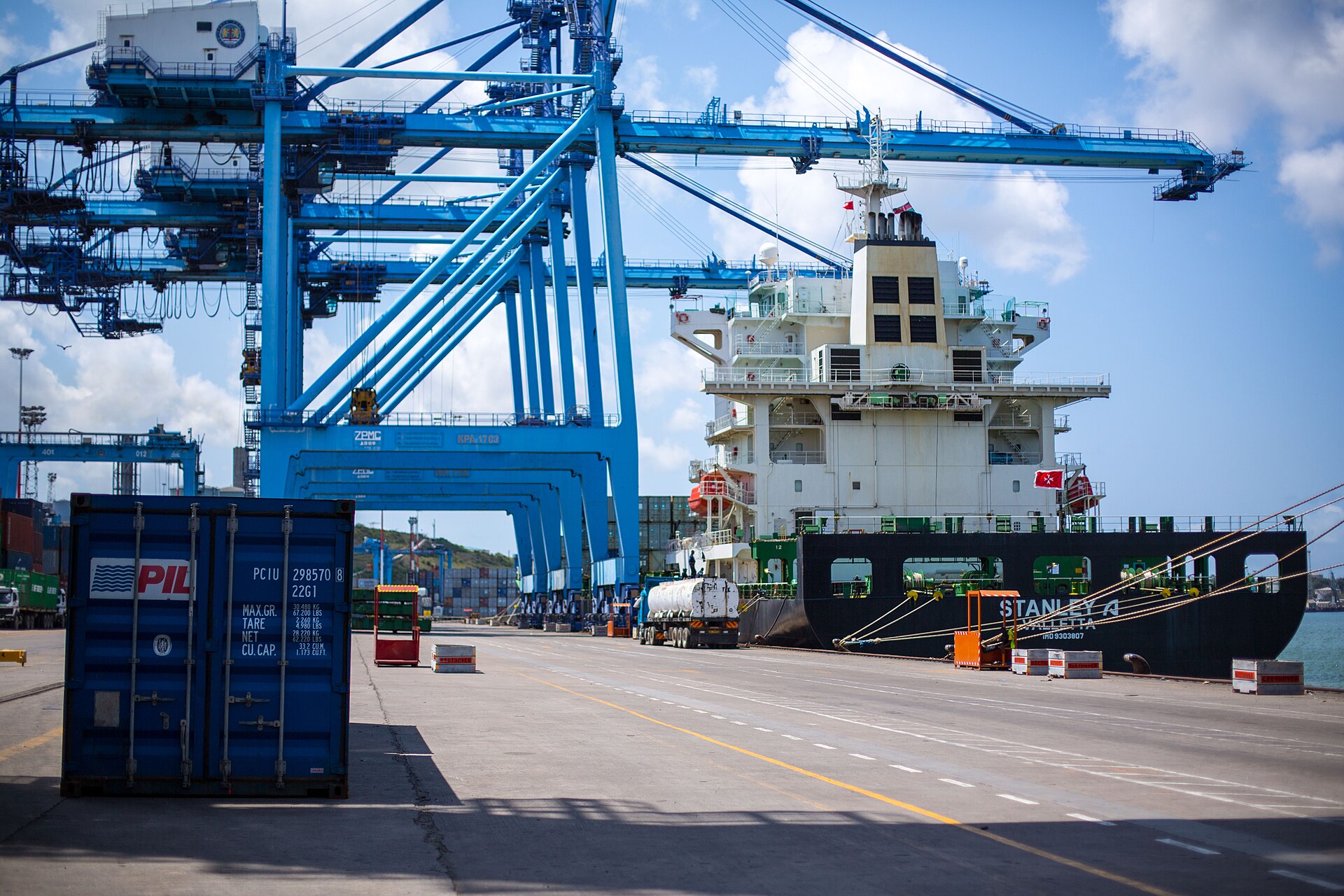 A ship docked at the Port of Mombasa, Kenya, with cranes and containers