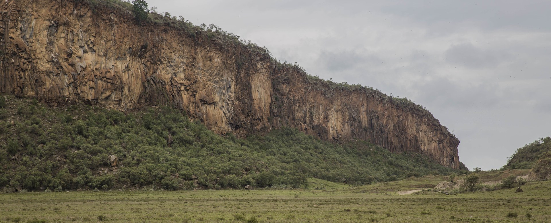 A long volcanic escarpment over grassland in Hell's Gate National Park, Kenya
