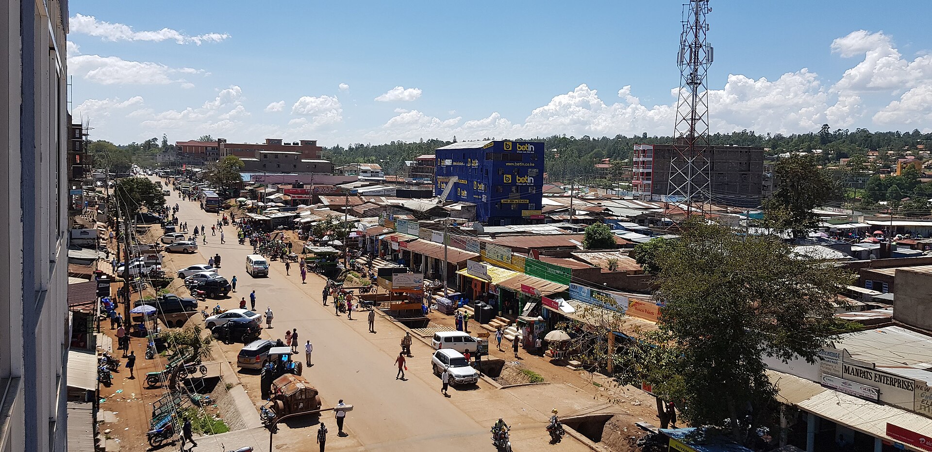 Migori town in western Kenya seen from above, with a main street, shops and a telecom mast