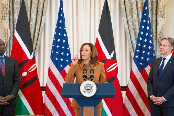 Kenyan President William Ruto at left and US Secretary of State Antony Blinken at right stand either side of US Vice President Kamala Harris, who speaks at a podium, with Kenyan and US flags behind them