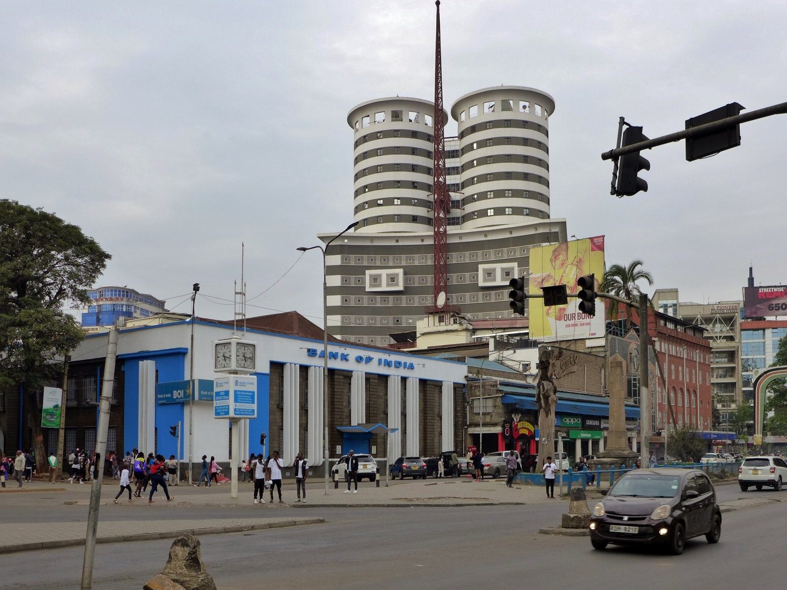 Traffic passes bank buildings and a round tower on Kenyatta Avenue in central Nairobi.