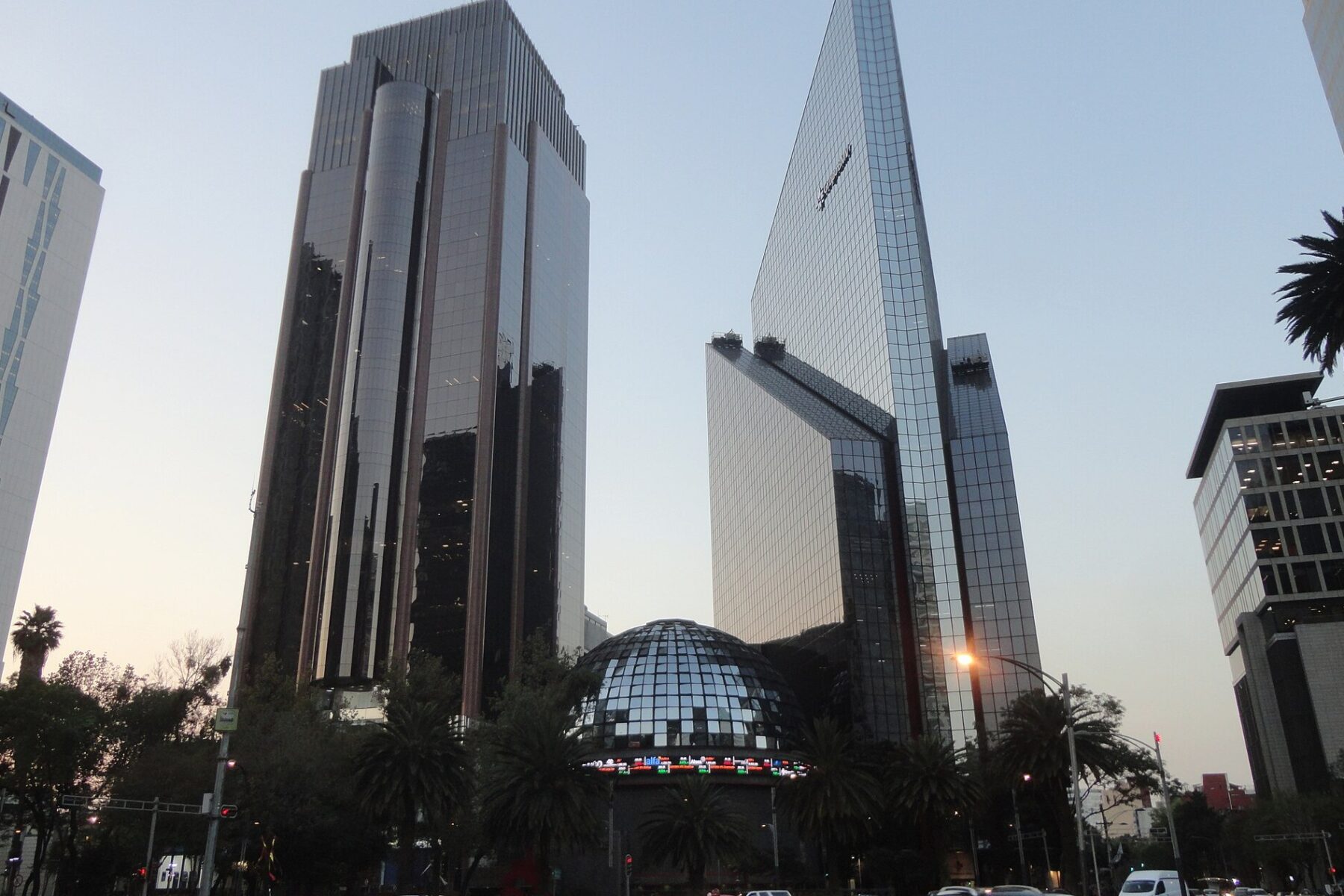The domed Mexican Stock Exchange building and office towers on Paseo de la Reforma in Mexico City at dusk