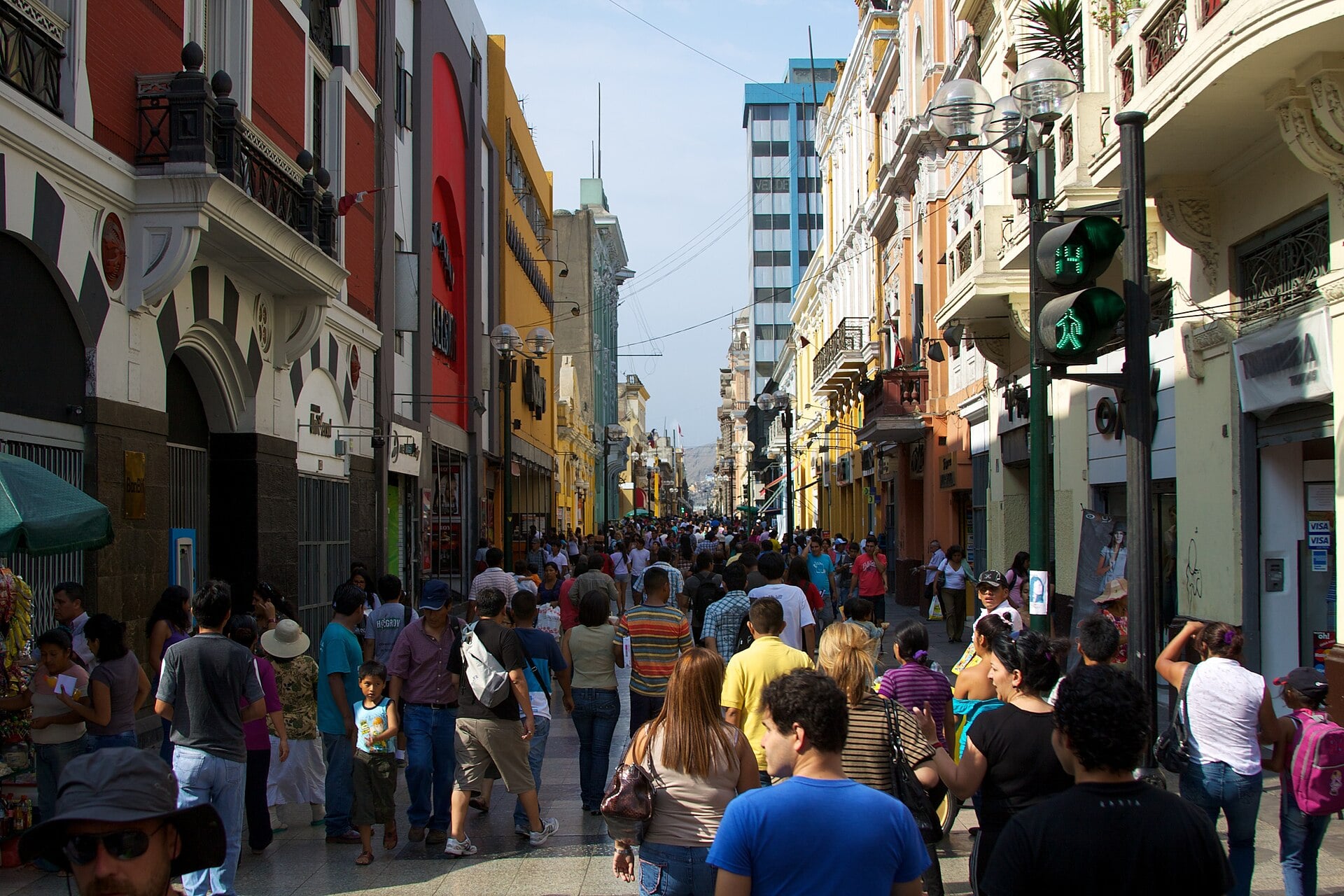 Crowds of pedestrians walking along the Jirón de la Unión shopping street in central Lima between colonial and modern buildings