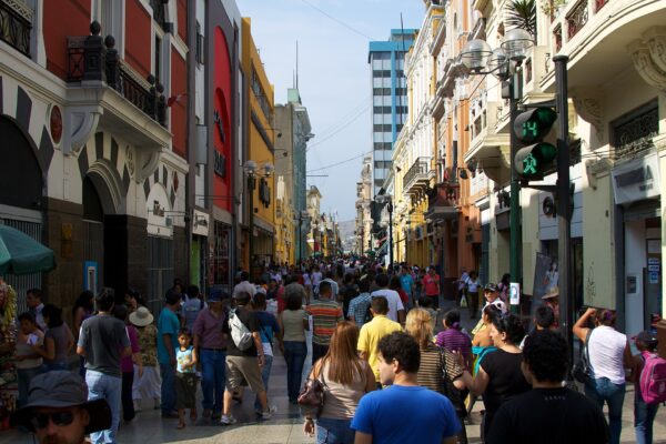 Crowds of pedestrians walking along the Jirón de la Unión shopping street in central Lima between colonial and modern buildings