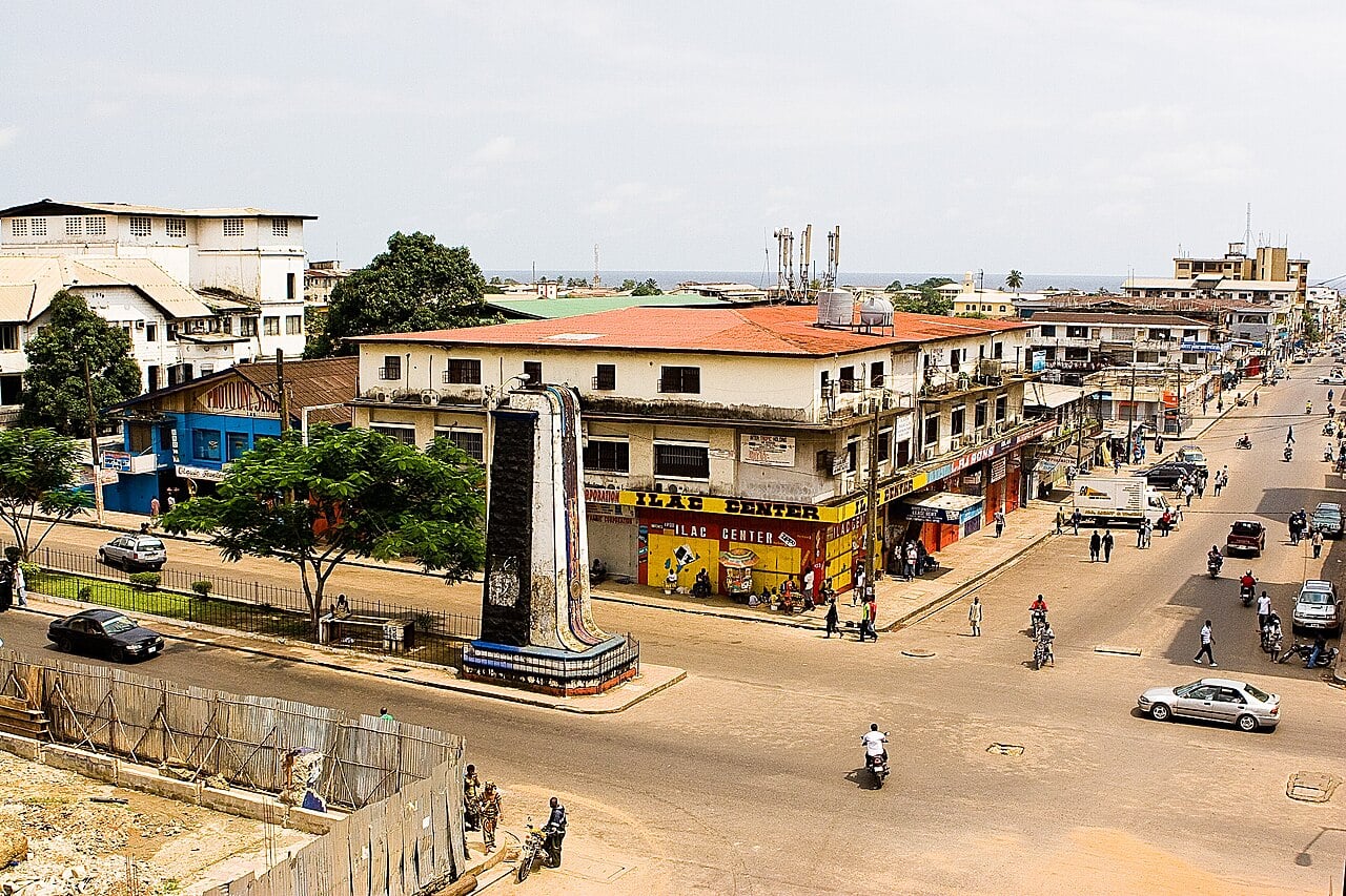 Street view with a monument in central Monrovia, Liberia, with the Atlantic Ocean on the horizon.