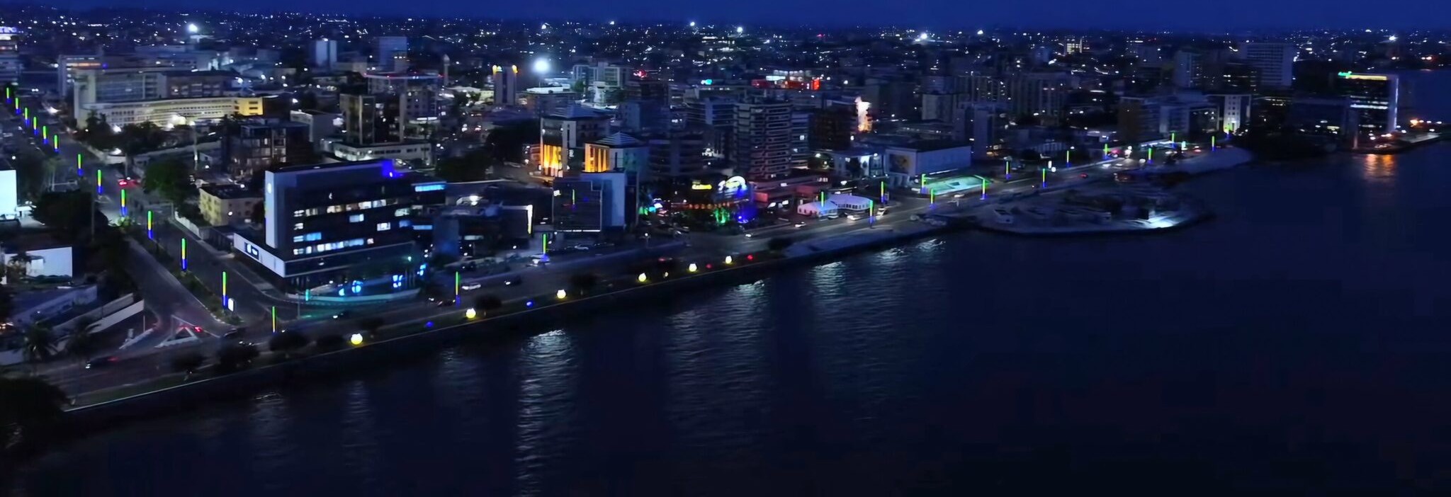 Aerial view of the lit waterfront and office towers of Libreville, Gabon, at dusk