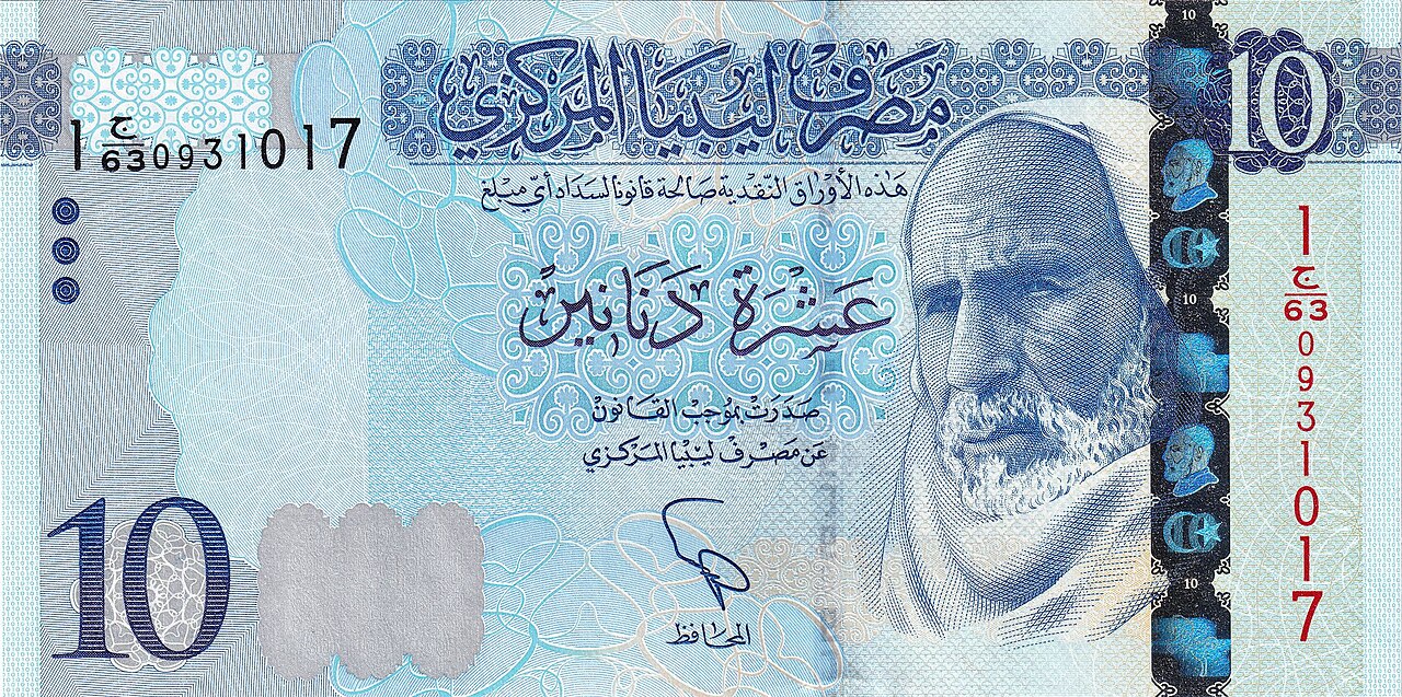 Libyan 10-dinar banknote in blue with the Central Bank of Libya name in Arabic and a bearded man in a head covering