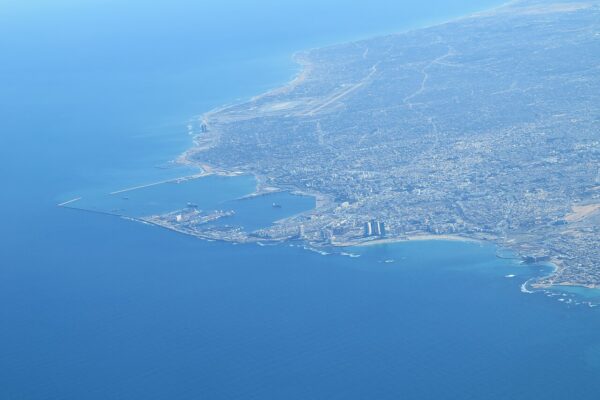 Aerial view of Tripoli, Libya, with its harbour breakwaters, city blocks and the coastline