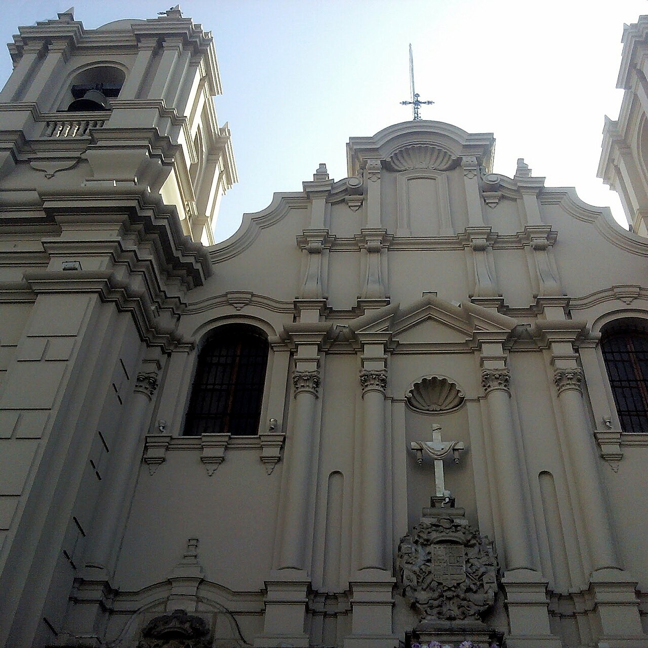 White colonial facade and bell tower of the Las Nazarenas church in Lima, seen from below against a pale sky