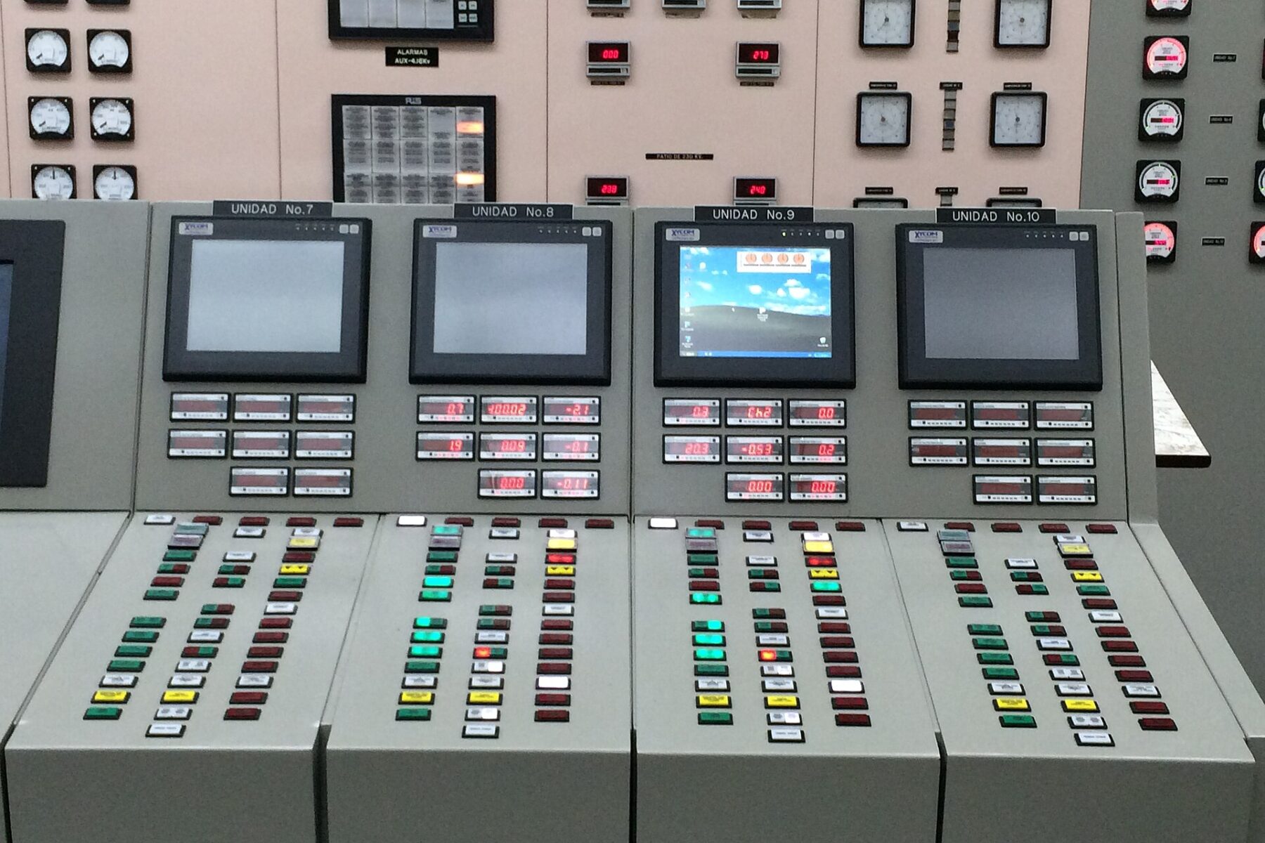 Control panels with screens, buttons and gauges for generating units 7 to 10 in the control room of the Guri hydroelectric plant in Venezuela