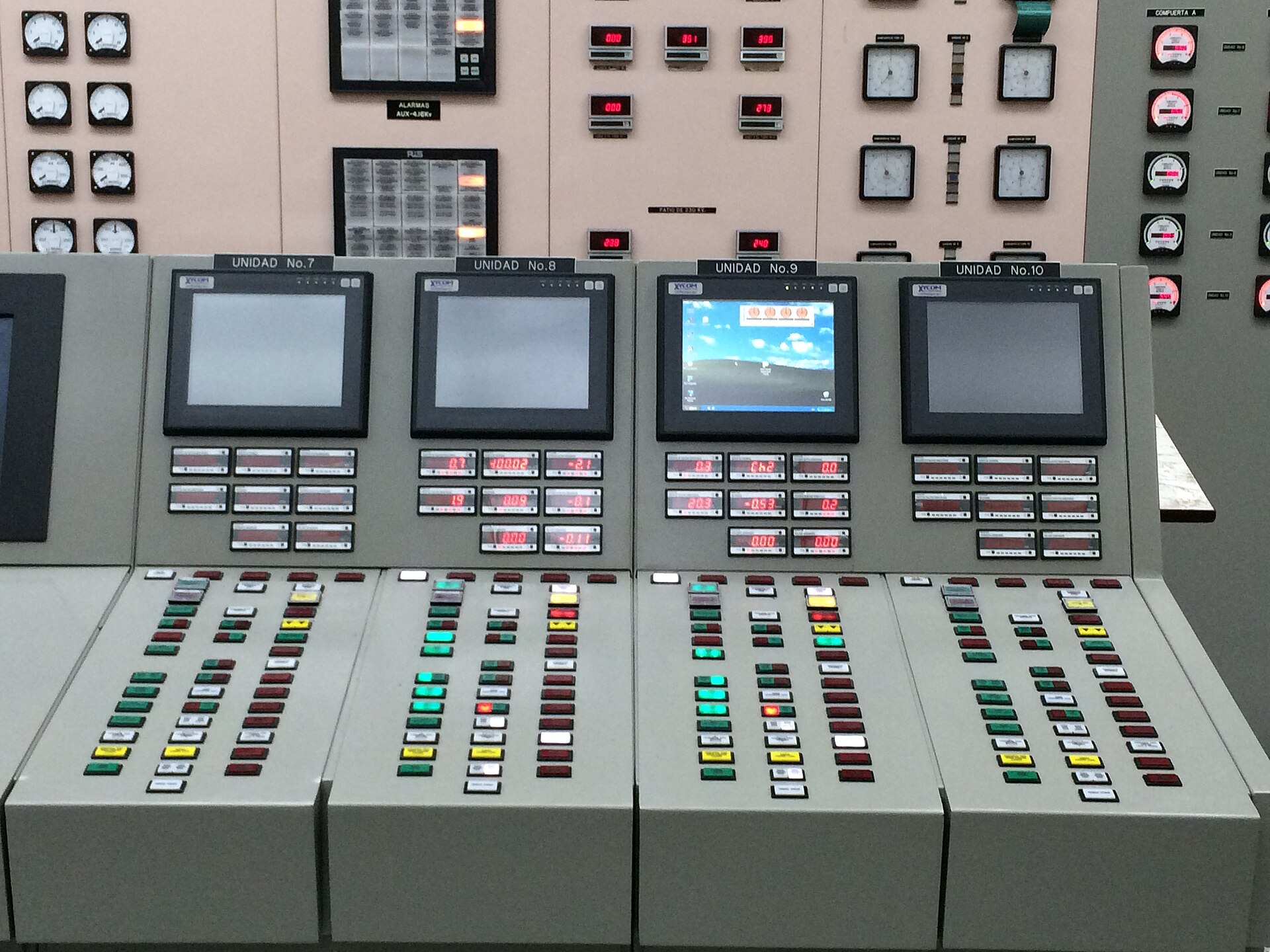 Control panels with screens, buttons and gauges for generating units 7 to 10 in the control room of the Guri hydroelectric plant in Venezuela