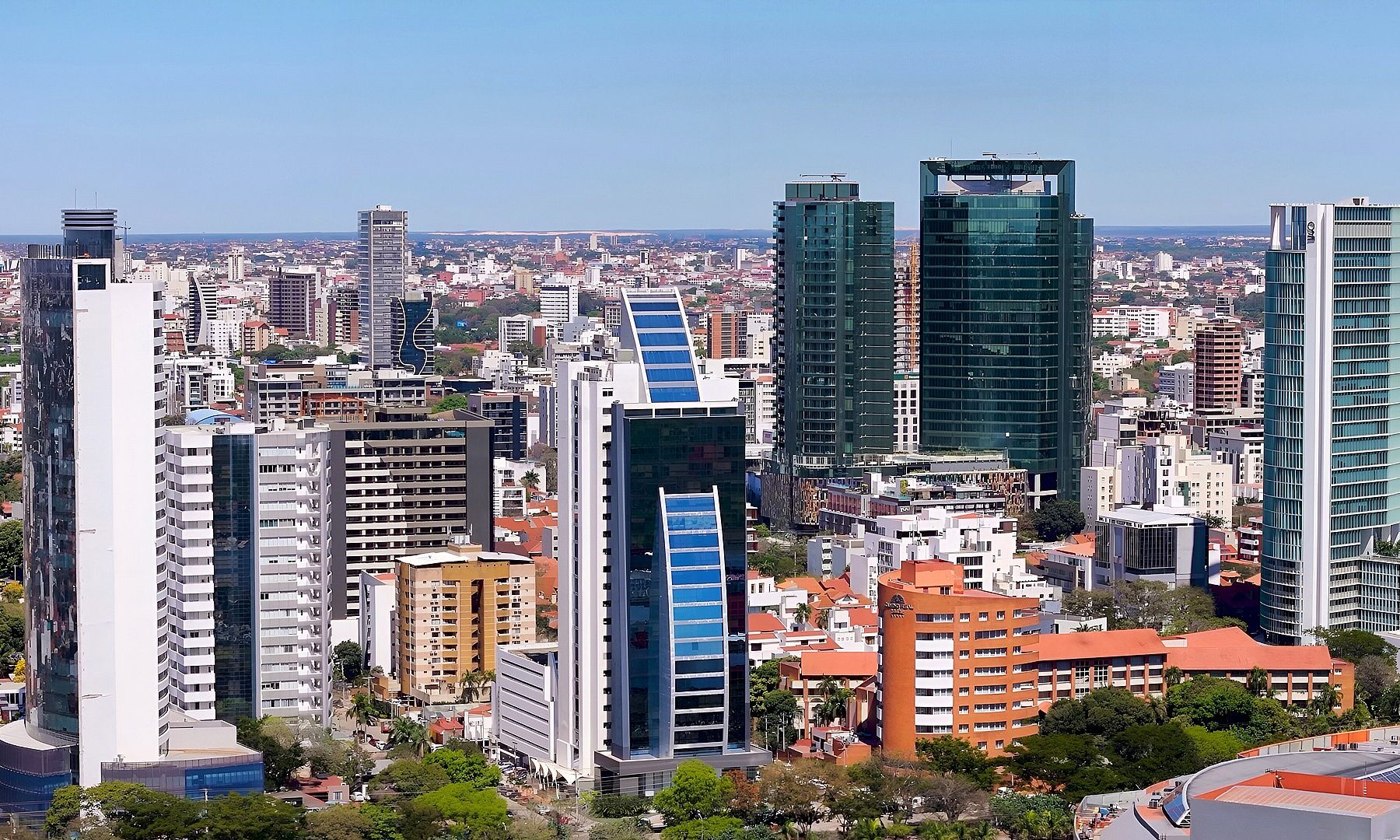 Glass and concrete high-rise towers of central Santa Cruz de la Sierra under a clear blue sky