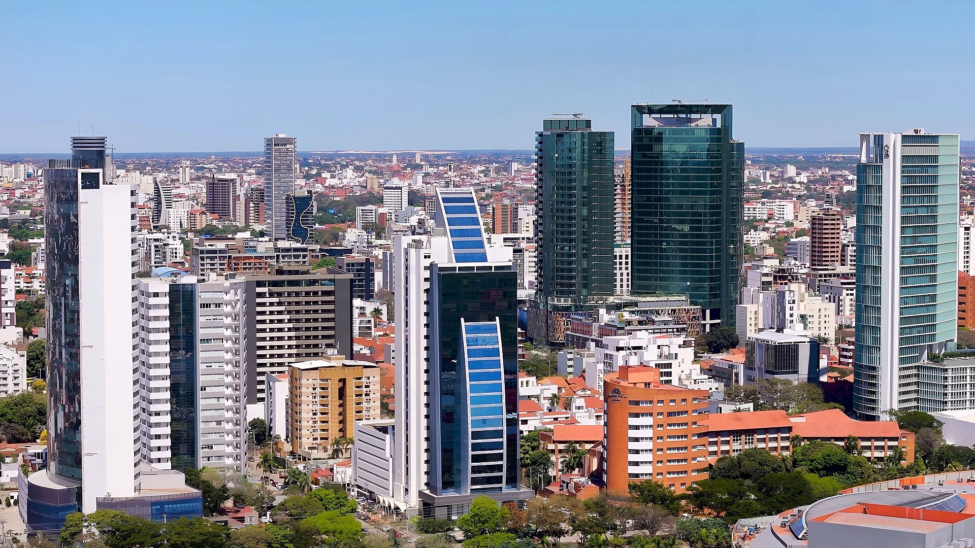 Glass and concrete high-rise towers of central Santa Cruz de la Sierra under a clear blue sky