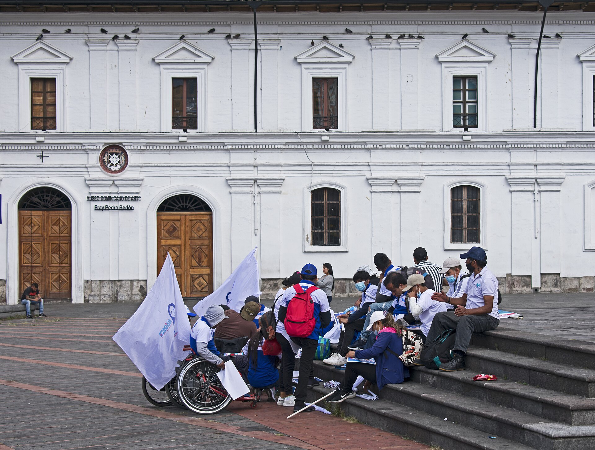 Supporters of Luisa González with flags on the steps of Plaza de Santo Domingo in Quito, Ecuador