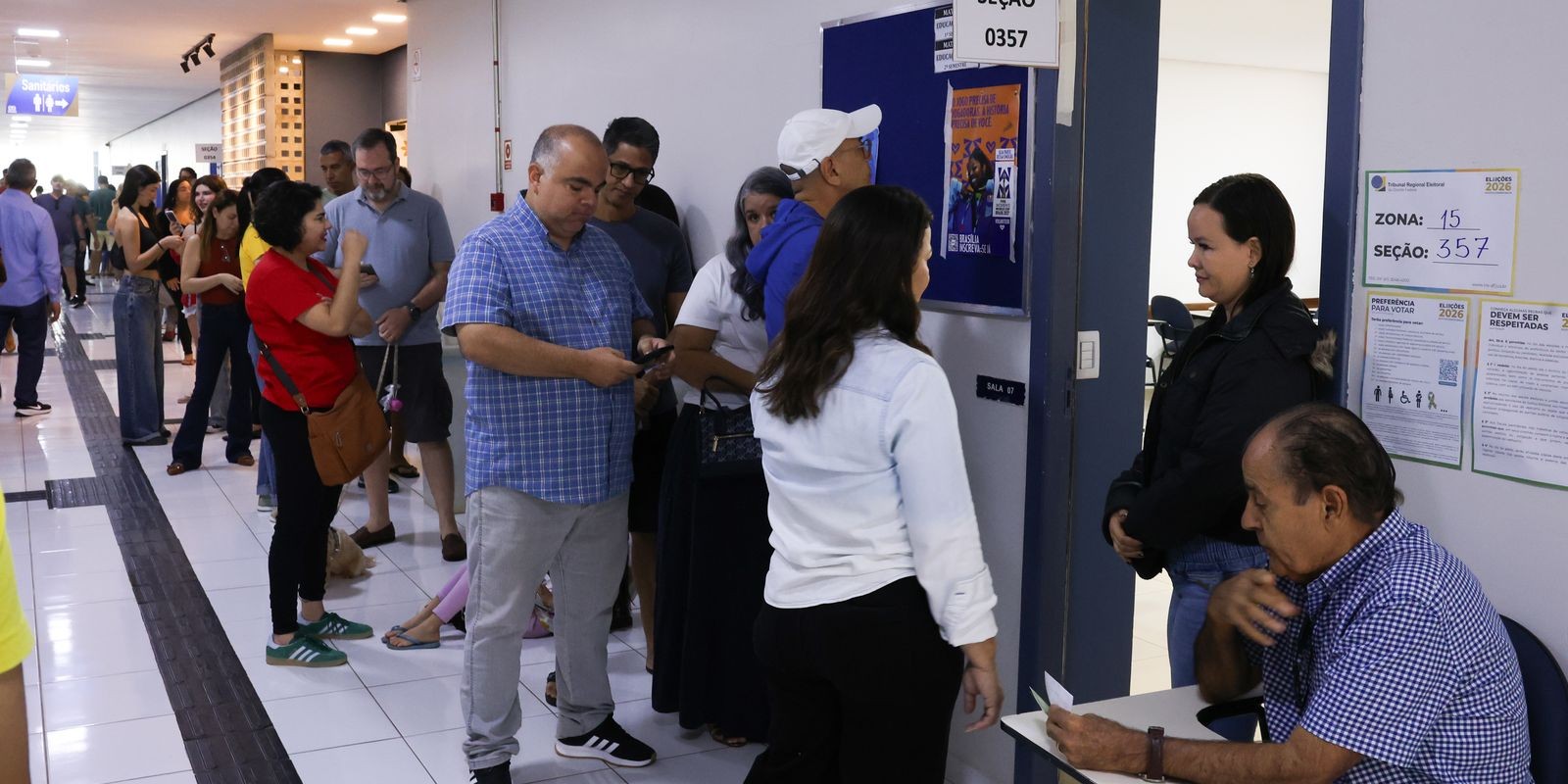 Voters queue in a school corridor at a polling station in Brazil’s Federal District during the 2026 elections