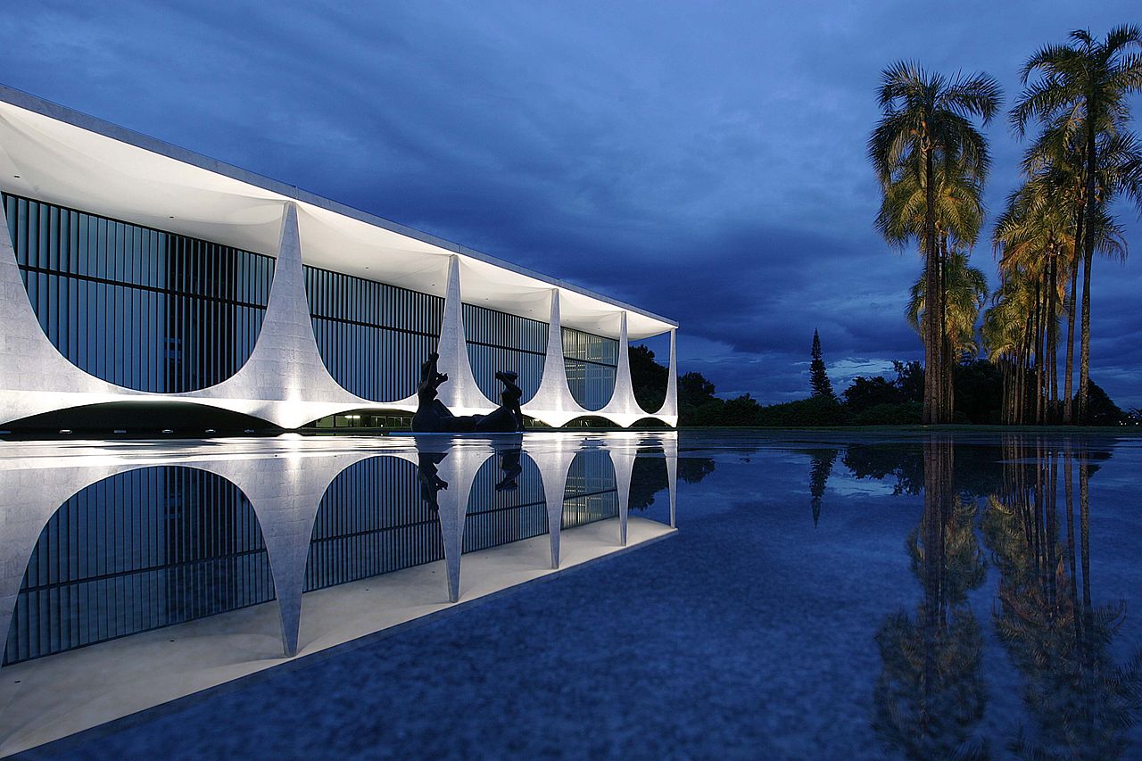 Palácio da Alvorada, the official residence of Brazil's president in Brasília, lit at dusk beside a reflecting pool