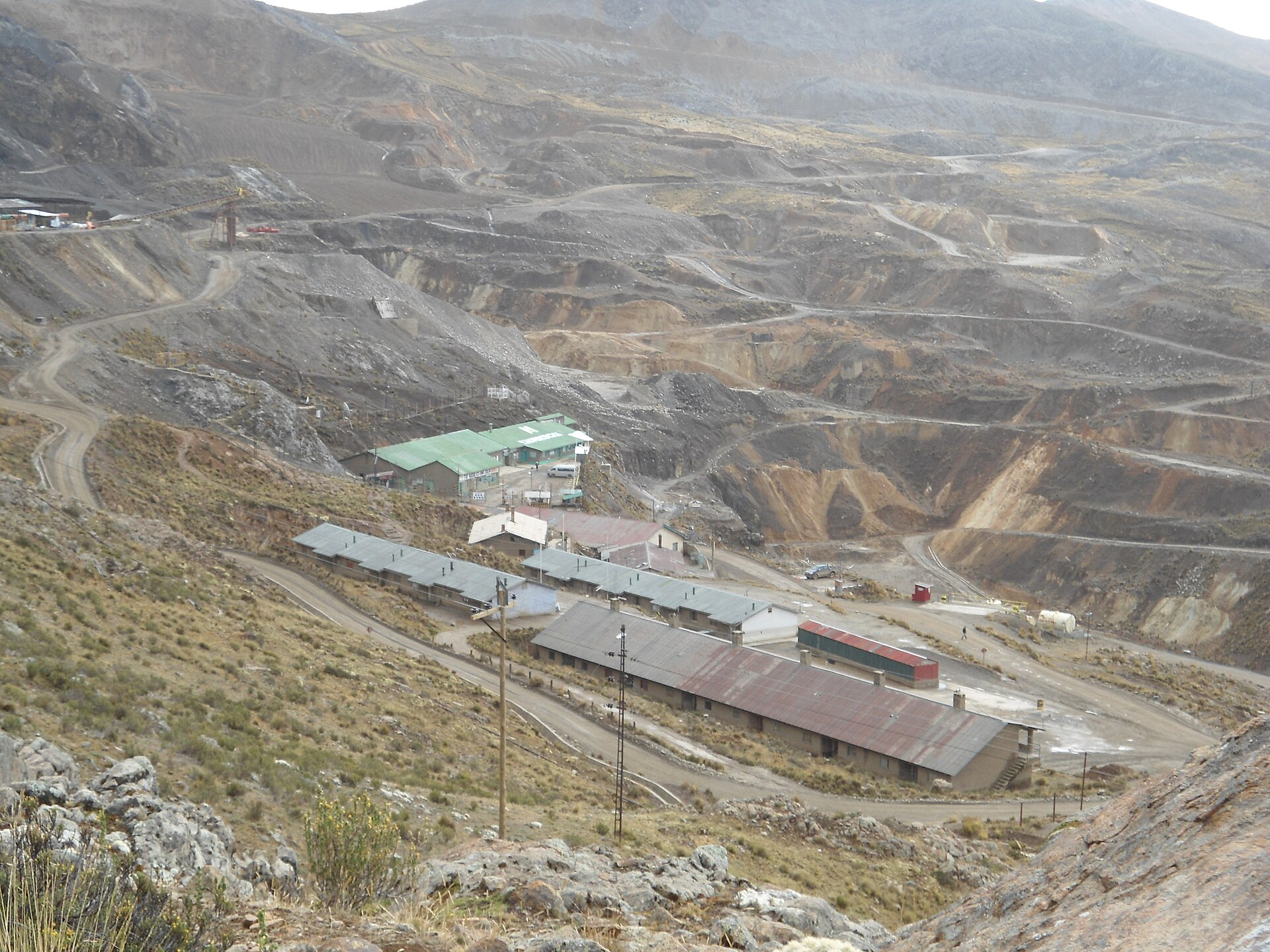 Mine buildings and terraced open workings on a high Andean hillside in Peru