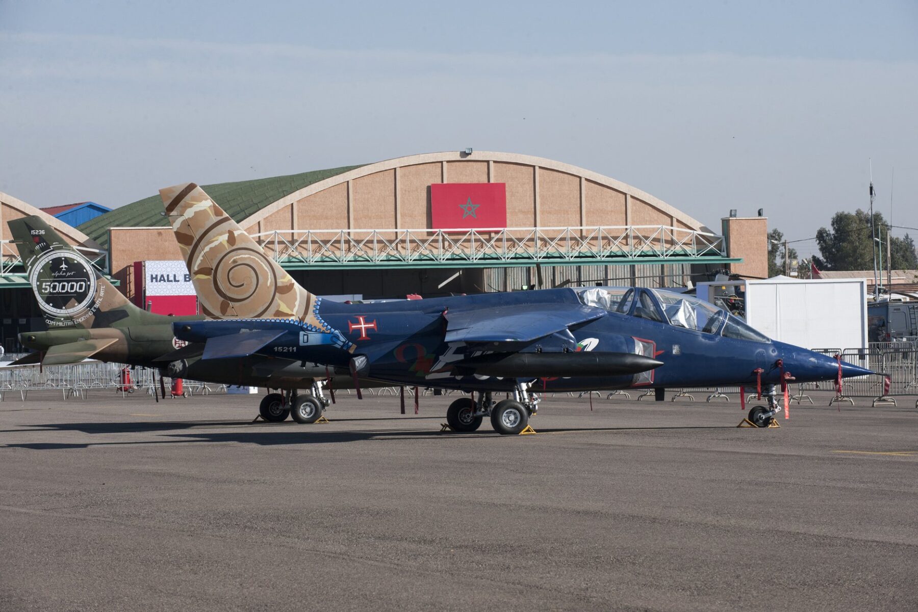 Jets parked in front of a hangar with the Moroccan flag at the Marrakech Air Show