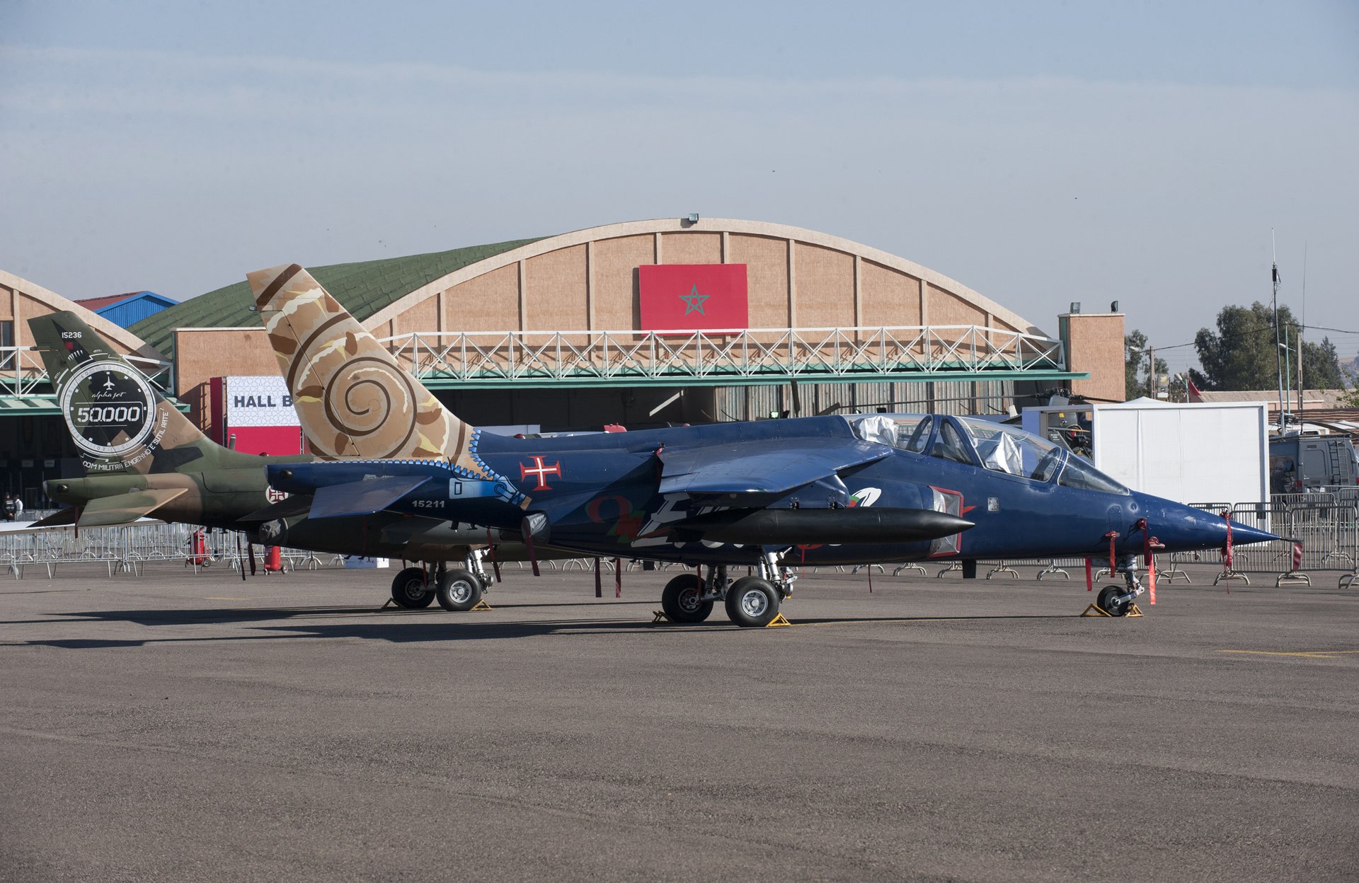 Jets parked in front of a hangar with the Moroccan flag at the Marrakech Air Show