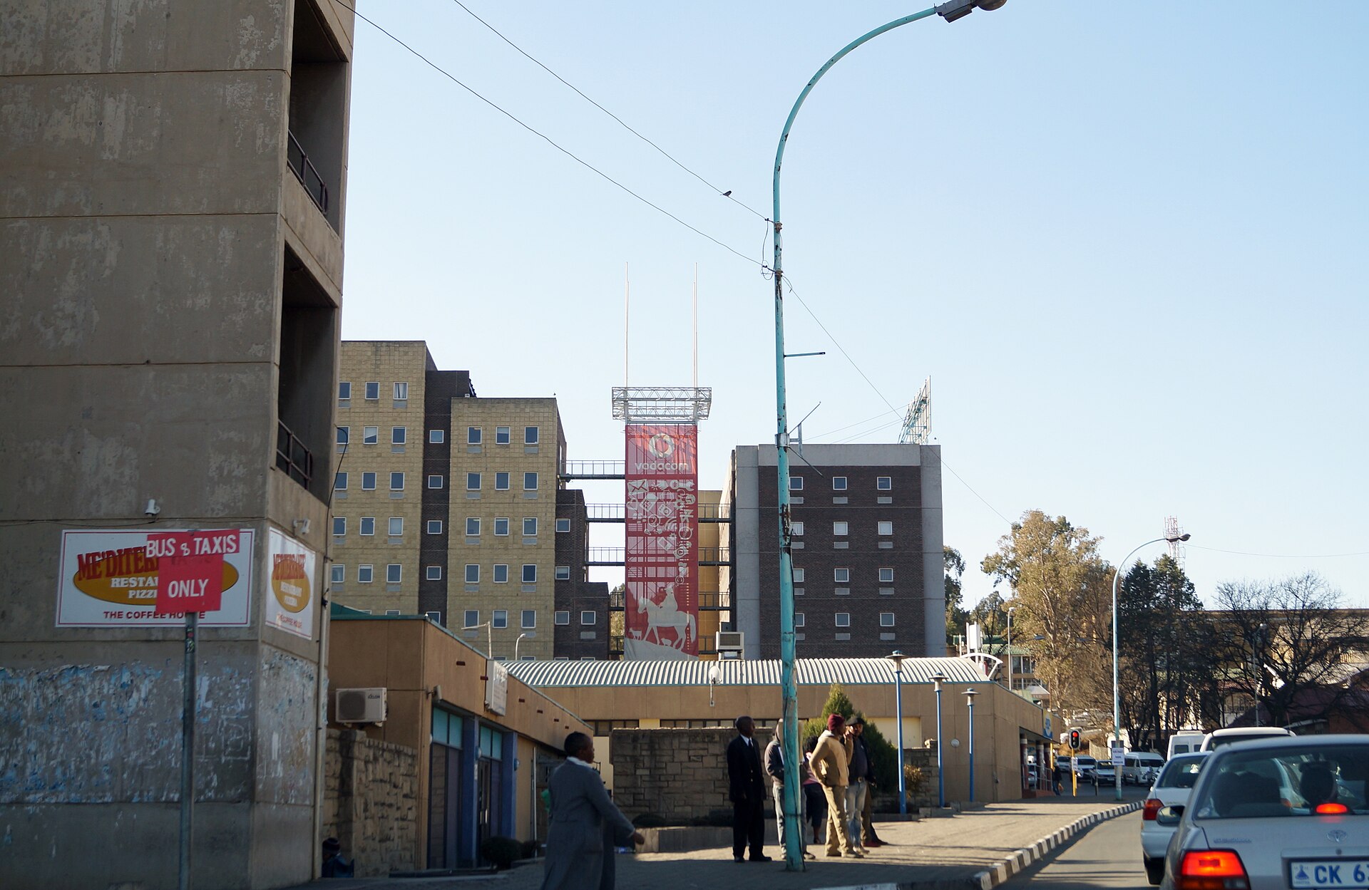 Kingsway Road in central Maseru with traffic, pedestrians and office blocks