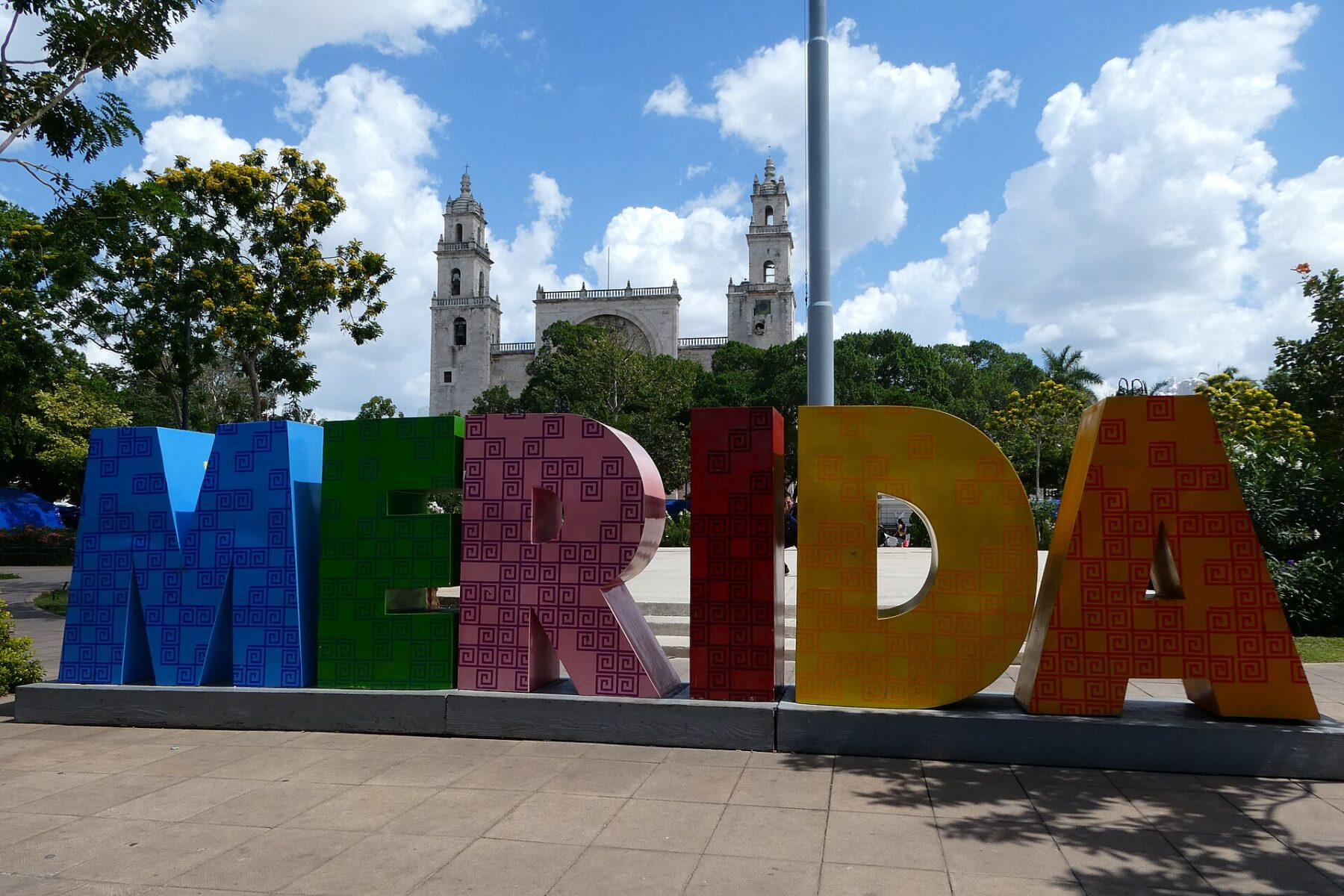 Colourful MÉRIDA letters with the cathedral towers in the background