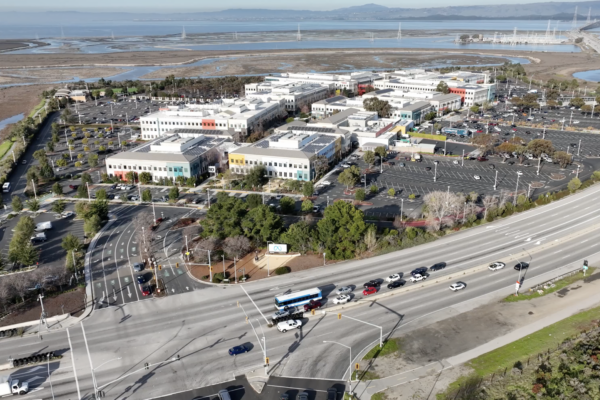 Aerial view of the Meta headquarters campus in Menlo Park, California, beside a highway and the bay