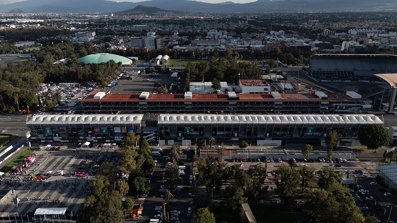 Drone view of the main grandstand and pit building of the Autodromo Hermanos Rodriguez with the Palacio de los Deportes dome behind