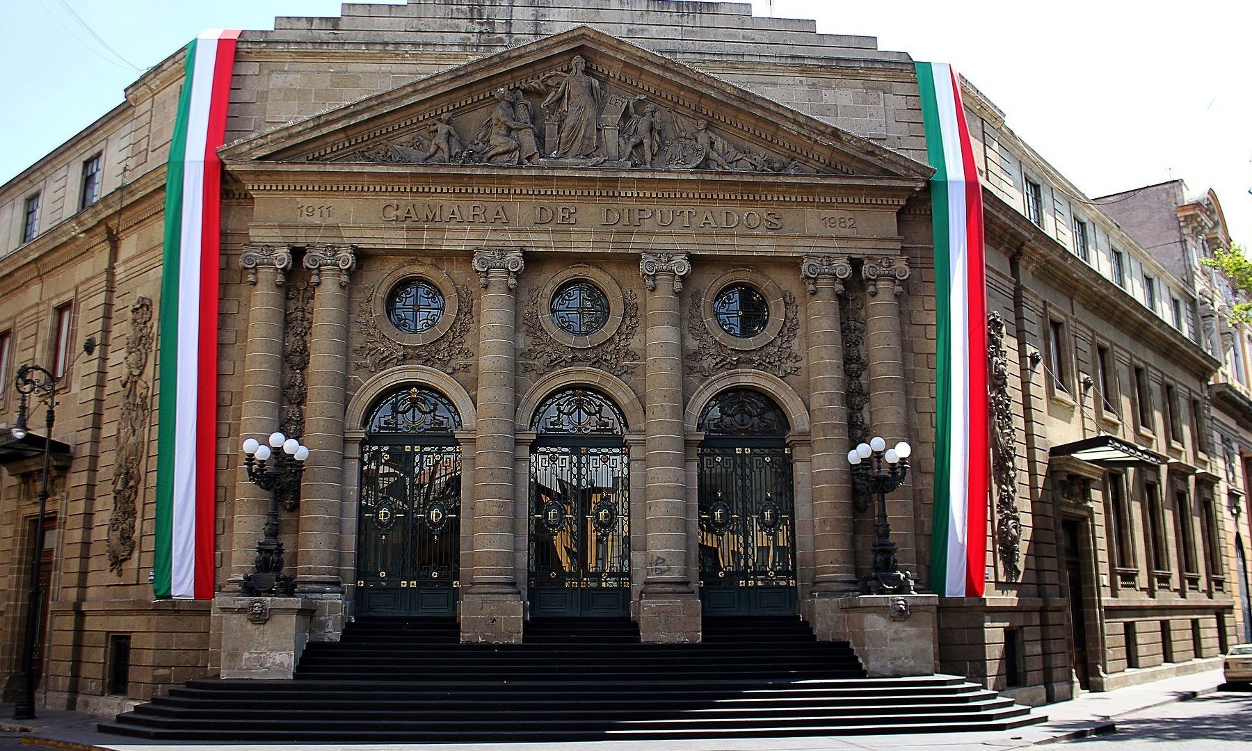 The Donceles building in historic Mexico City, with Mexican flags on its facade