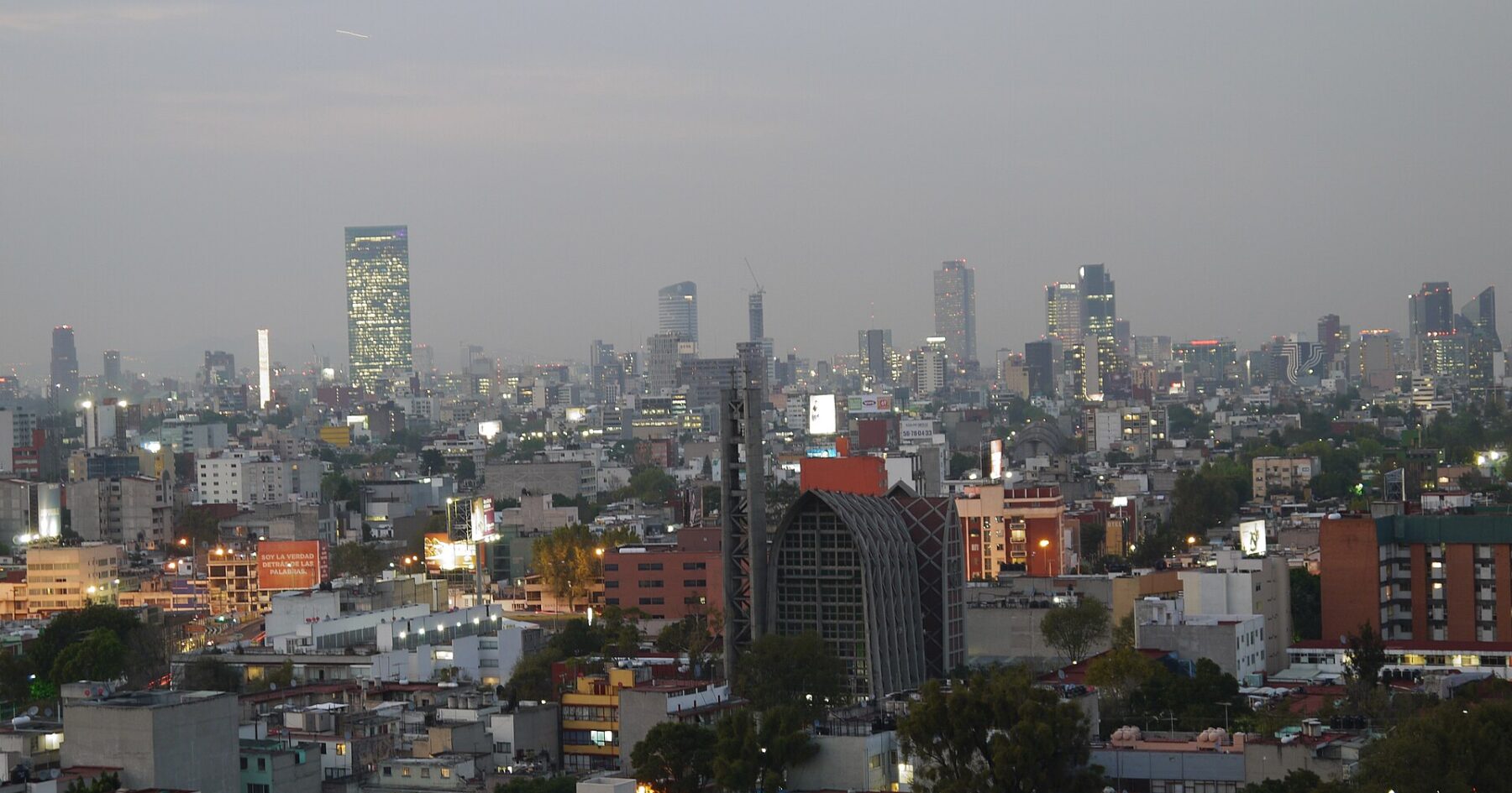 Mexico City skyline along Paseo de la Reforma with mountains behind