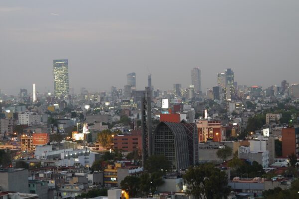 Mexico City skyline along Paseo de la Reforma with mountains behind