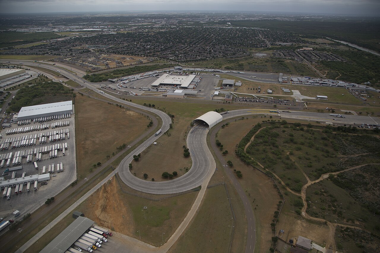 Aerial view of highway ramps and truck parking lots near the Laredo border cargo crossing in Texas