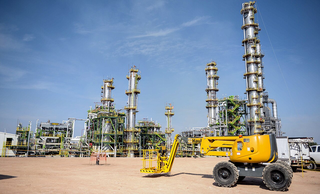 Process towers and pipework at the Tula refinery in Hidalgo, Mexico, with a yellow lift platform in the foreground