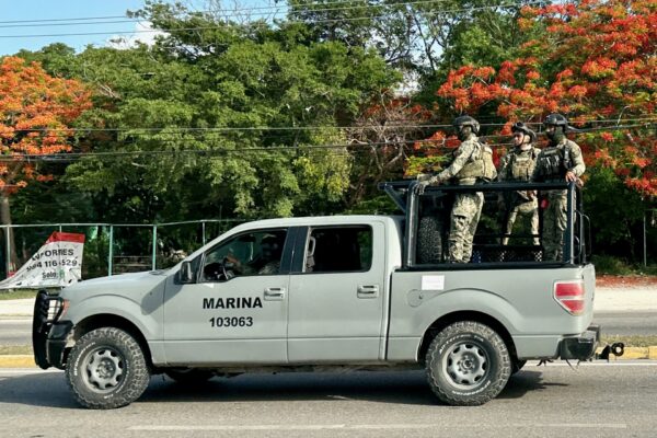 Mexican Navy pickup truck carrying three armed marines in camouflage on a road in Mexico