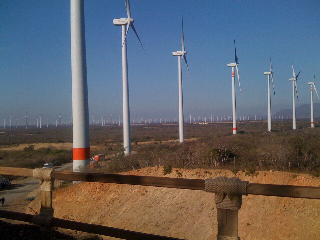 Rows of wind turbines on a hillside at a wind farm in Mexico