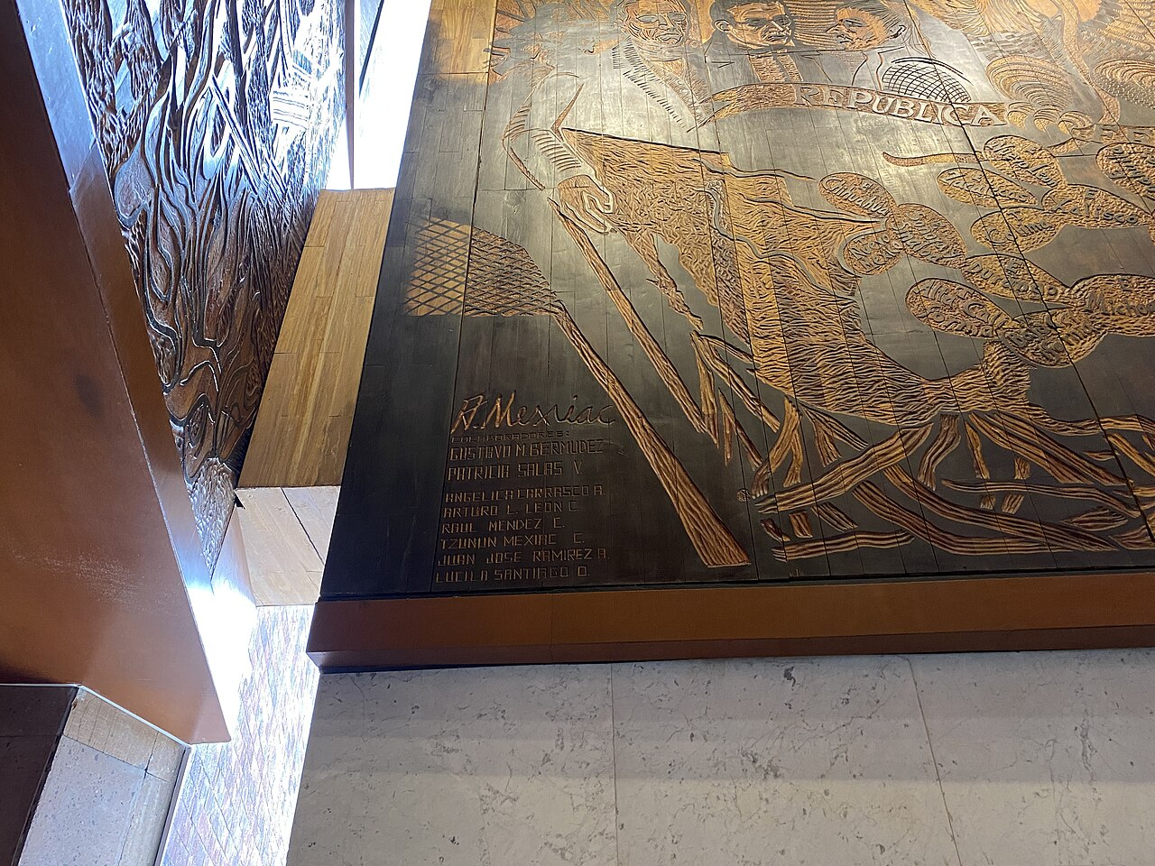 Signature of artist Adolfo Mexiac on a carved wooden mural in the lobby of San Lázaro Legislative Palace in Mexico City