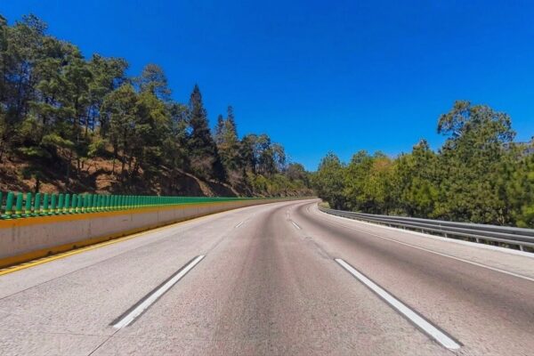 The Mexico City to Puebla highway curves through pine forest in central Mexico