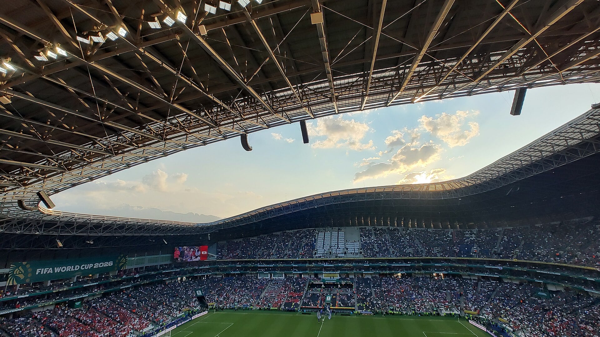 Inside Estadio BBVA in Monterrey at sunset, seen from the upper stand under the roof