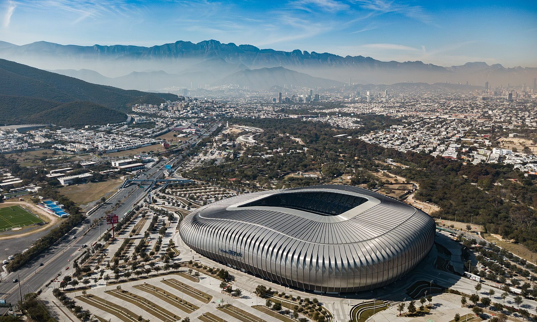 Aerial view of Estadio BBVA in Guadalupe, Monterrey, with the Sierra Madre mountains behind