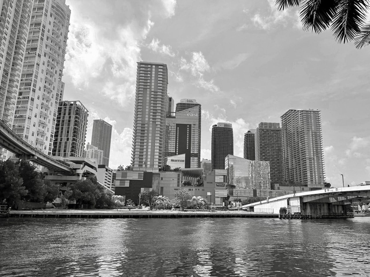 Black-and-white view of high-rise towers beside the Miami River near Brickell in Miami, Florida