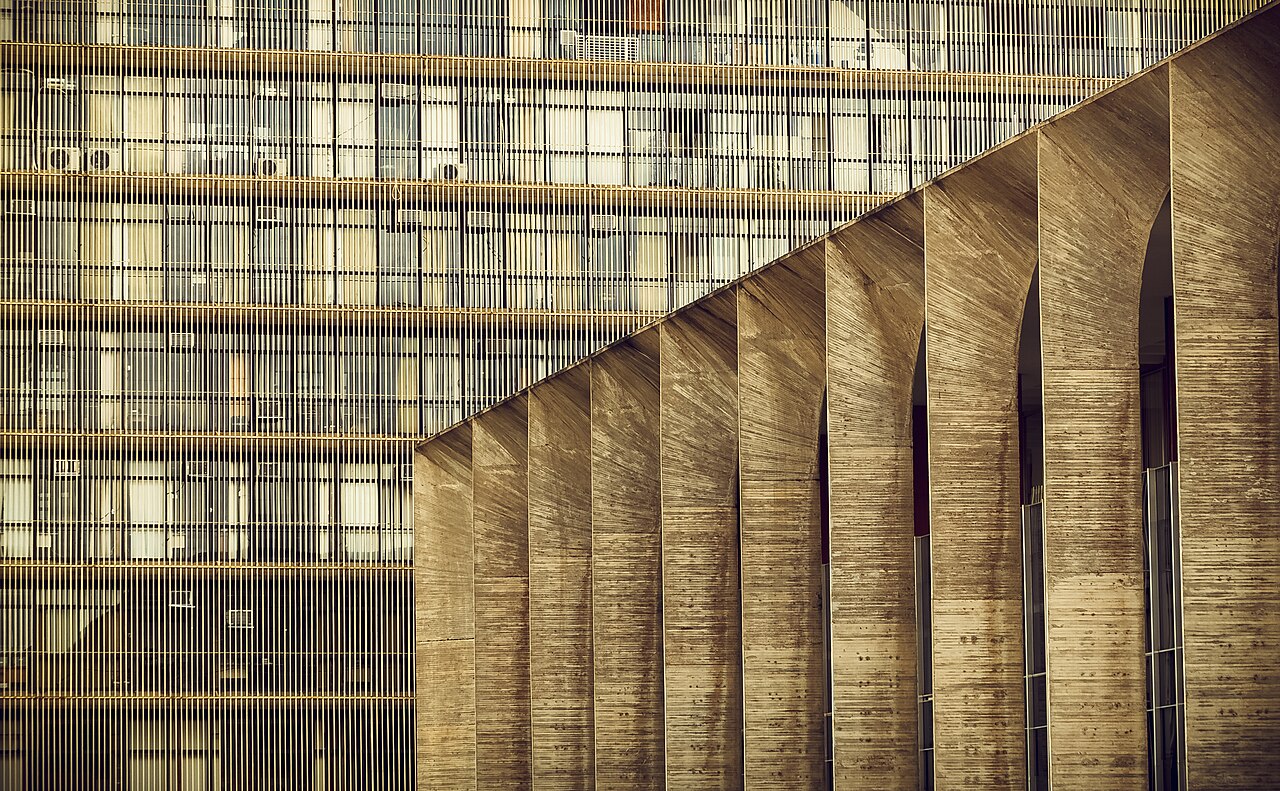 The tall concrete arches of the Itamaraty Palace in Brasília in front of a ministry office block