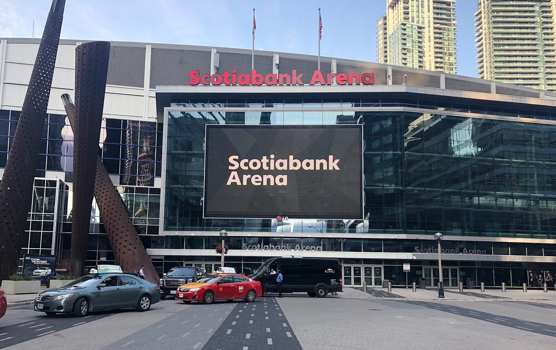 Front of Scotiabank Arena in Toronto with a large screen reading Scotiabank Arena and cars on the street below