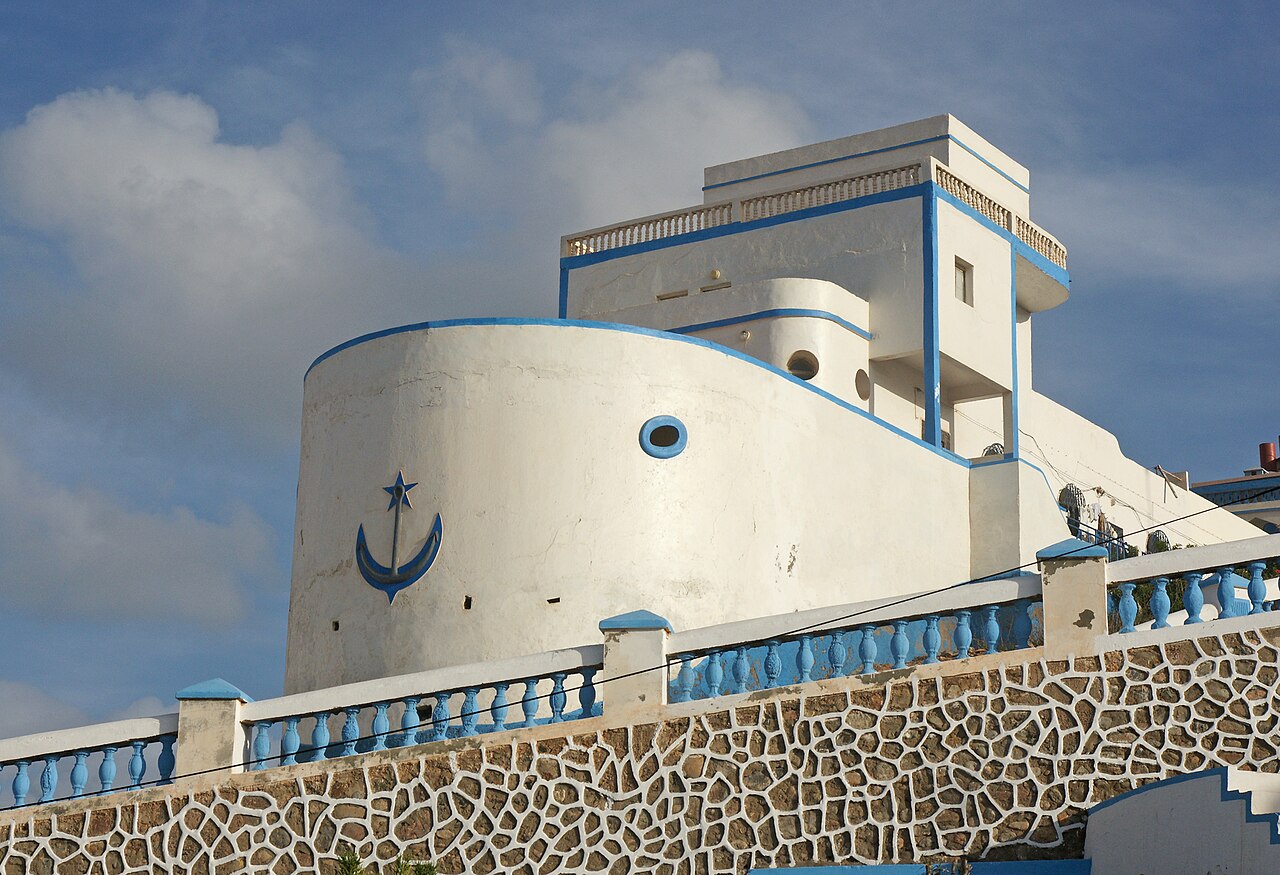 The ship-shaped white and blue Art Deco former admiralty building in Sidi Ifni with an anchor emblem