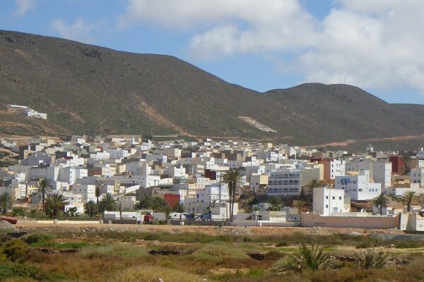 White houses of the Atlantic town of Sidi Ifni in southern Morocco below dry brown hills