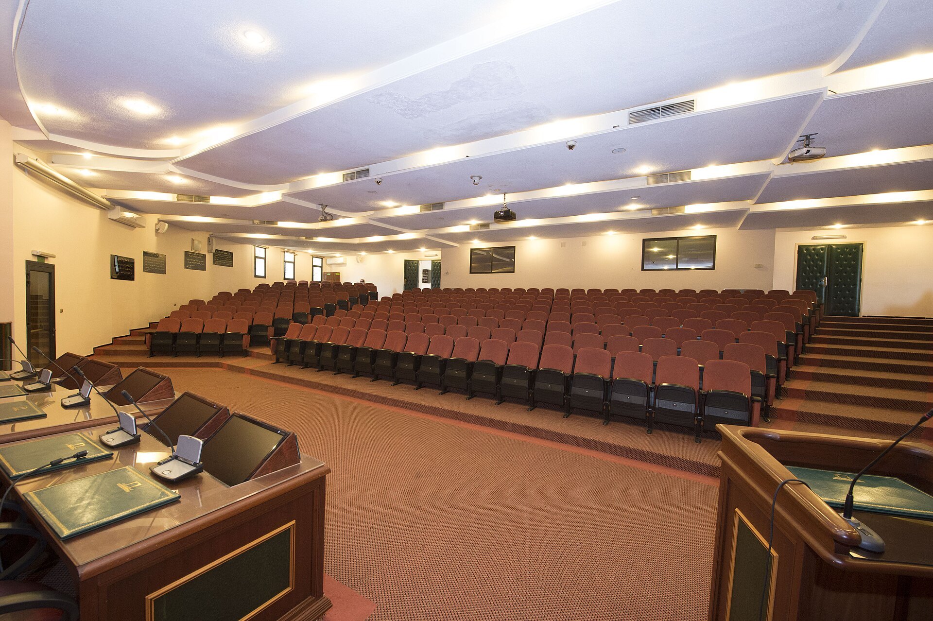 Empty lecture hall with rows of red seats and a speakers table at the Ecole Nationale Superieure de l Administration in Rabat, Morocco