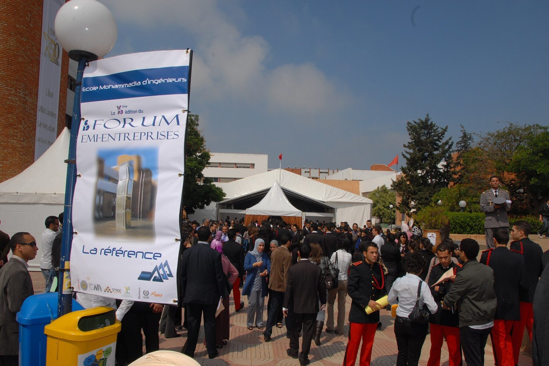 Crowd at the Forum EMI-Entreprises careers fair of the Ecole Mohammadia d Ingenieurs engineering school in Rabat, Morocco, with uniformed students in the foreground