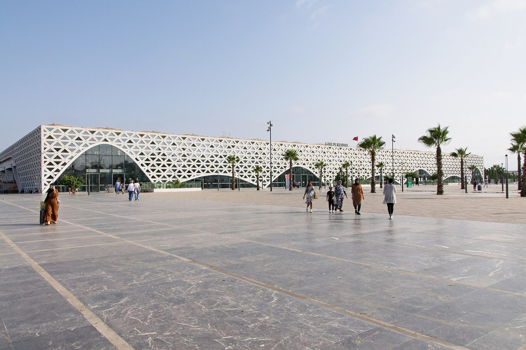 Kenitra high-speed railway station in Morocco, with its white lattice facade and palm trees
