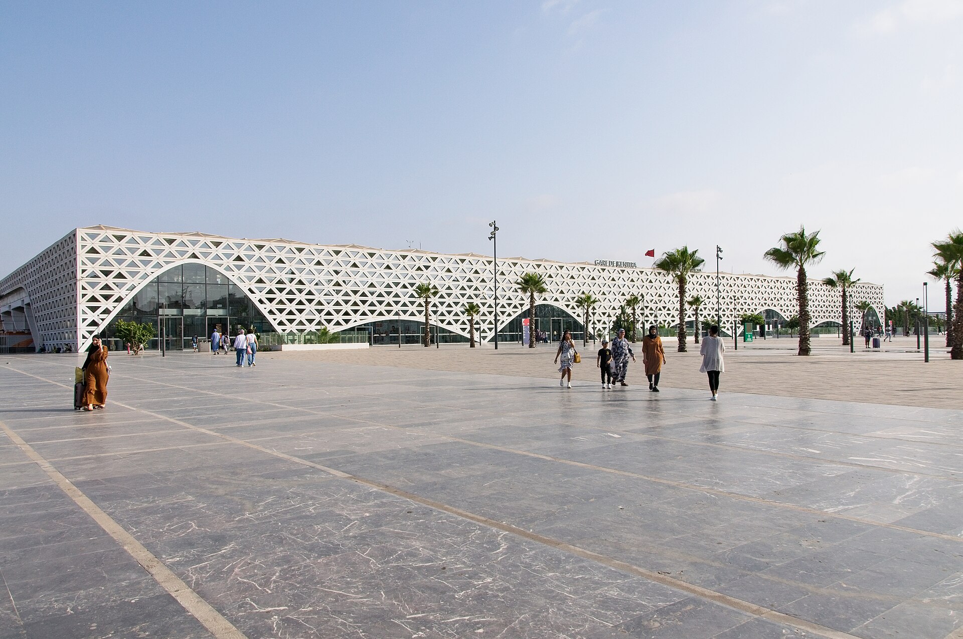 Kenitra high-speed railway station in Morocco, with its white lattice facade and palm trees